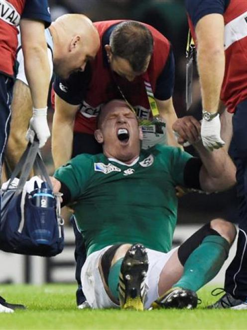 Ireland captain Paul O'Connell receives treatment after sustaining an injury in their win over...