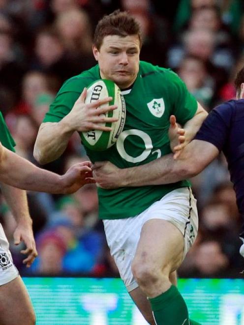 Ireland's Brian O'Driscoll (C) tries to break through the Scotland defence. REUTERS/Cathal...