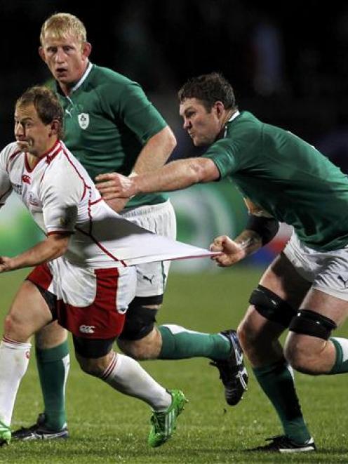 Ireland's Donnacha Ryan grabs onto Russia captain Alexander Yanyushkin during their Rugby World...