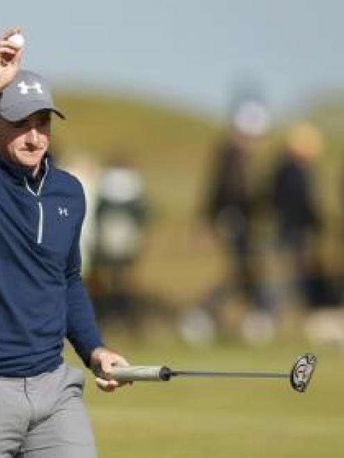 Irish amateur Paul Dunne reacts after his birdie putt on the 15th hole during the third round of...