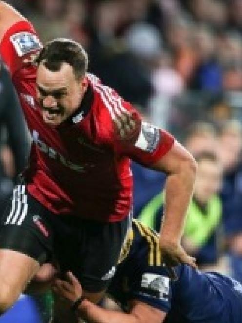 Israel Dagg of the Crusaders looks to pass in a tackle during the round 19 Super Rugby match...