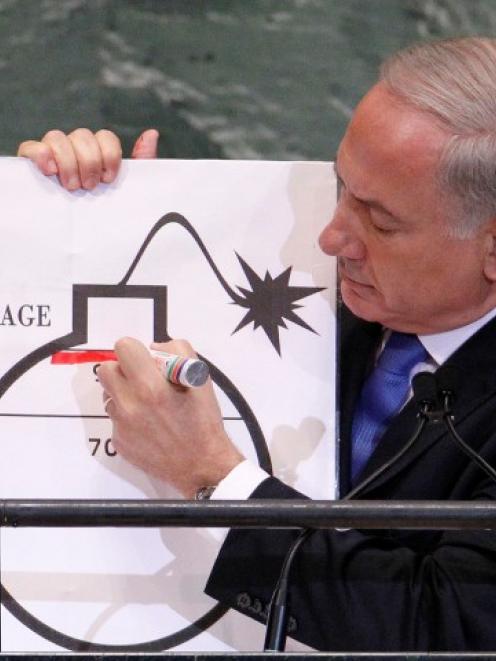 Israel Prime Minister Benjamin Netanyahu draws a red line on a graphic of a bomb as he addresses...