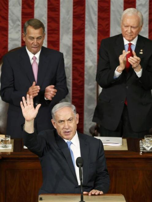 Israeli Prime Minister Benjamin Netanyahu acknowledges applause at the end of his speech to a...