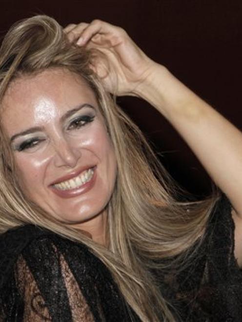 Italian escort Patrizia D'Addario smiles during an Italian style party named "I love Silvio", in...