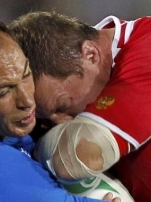 Italy captain Sergio Parisse (left) tackles Russia captain Vladislav Korshunov during their Rugby...