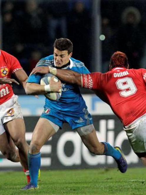 Italy's Tommaso Iannone fights for the ball with Tonga's Taniela Moa . REUTERS/Alessandro Garofalo