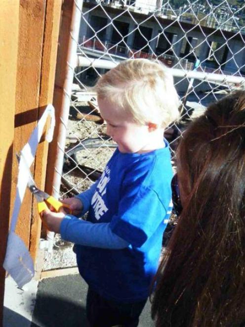 Jack Smillie (3) cuts the ribbon to mark the official opening of the  Frankton Playcentre's new...