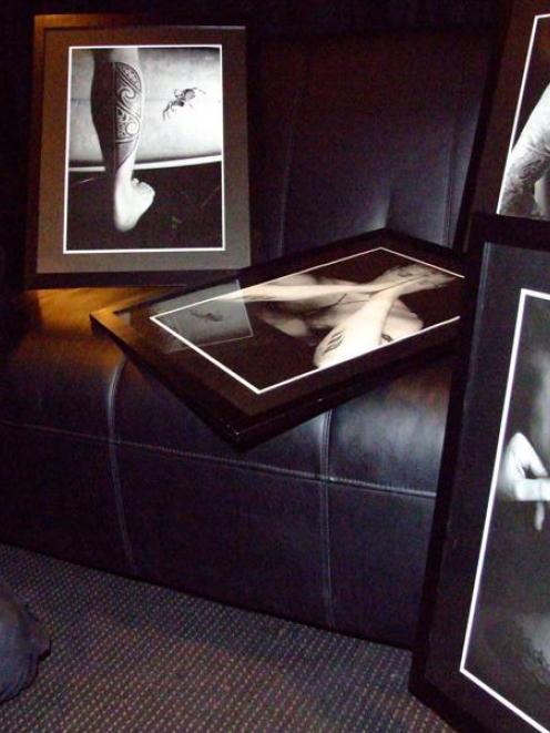 Jackie (Jax) Gay, of Still Vision Photography, studies some of her work which featured in the...