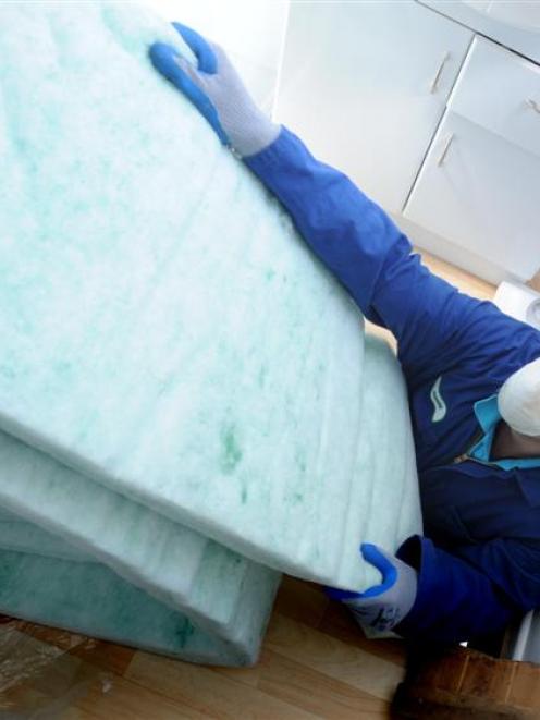 Jamahl Edwards, of Smart Energy Solutions, prepares to install underfloor insulation at a Mosgiel...