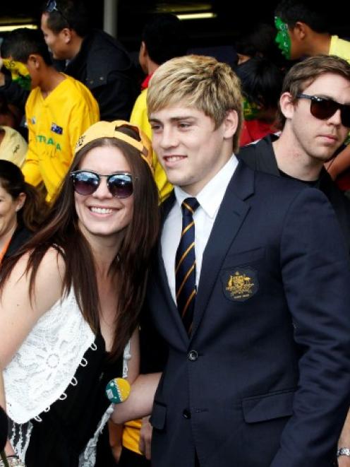 James O'Connor takes pictures with a fan as he arrives with the Australian team at Auckland...