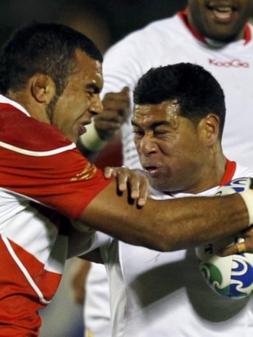 Japan's Michael Leitch (left) and Tonga's Siale Piutau (right) are two of 34 New Zealand-born...