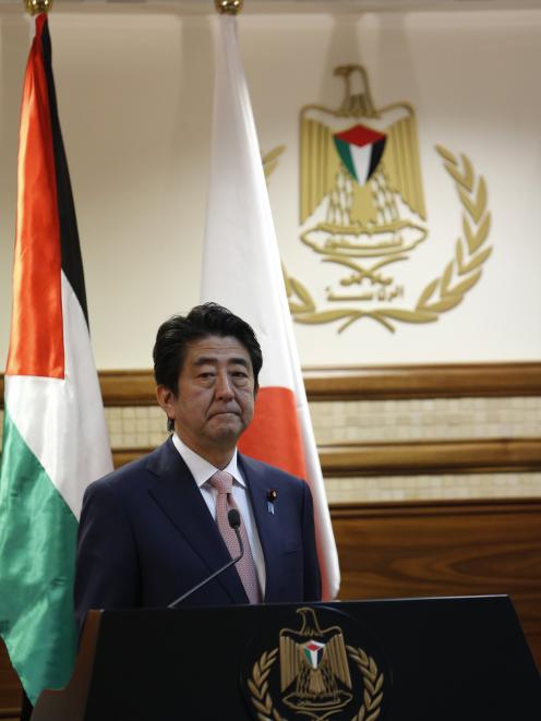 Japan's Prime Minister Shinzo Abe attends a joint news conference with Palestinian President...