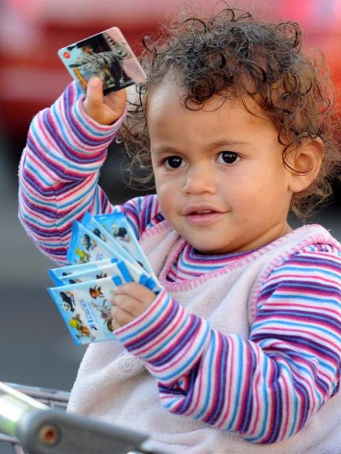 Jasmine Albrandt (2), of Waikouaiti, holds her DreamWorks Heroes action cards in central Dunedin....