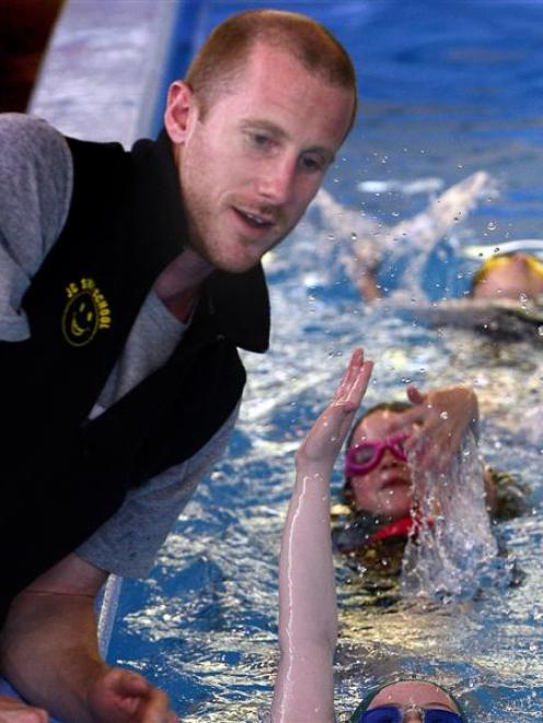 JC Swimming School instructor Kurt Crosland teaches Andersons Bay School pupils (from bottom)...