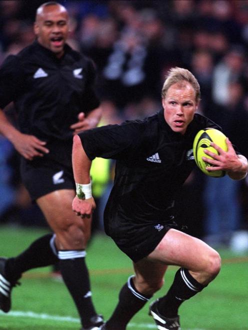 Jeff Wilson makes a break against France at Westpac Stadium in 2001. Jonah Lomu is in support....