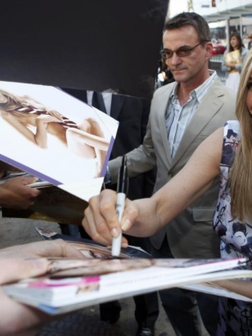 Jennifer Aniston signing autographs.