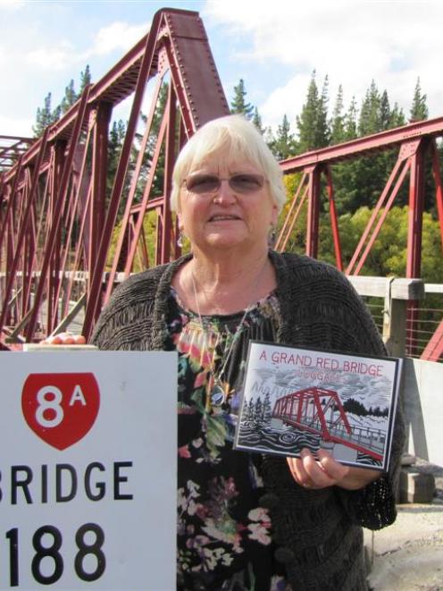 Jenny Moss, of Luggate, and the children's book she has written about the Red Bridge. Photo by...
