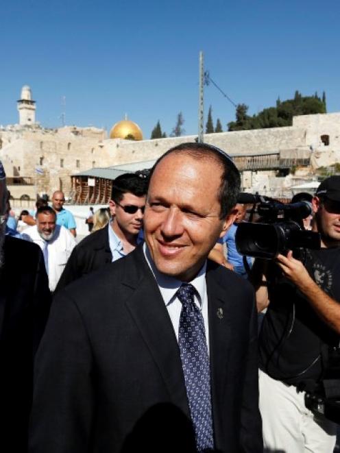 Jerusalem Mayor Nir Barkat (C) and his security guard wrestled a Palestinian attacker to the...