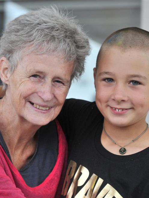 Jessica Power (9), of Ocean View, models her freshly shaved head with her grandmother, Carol...