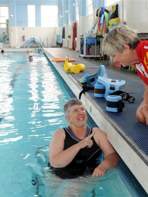 Jill Chalmers catches up with therapeutic pool supervisor Robyn Duggie during her swim in the...