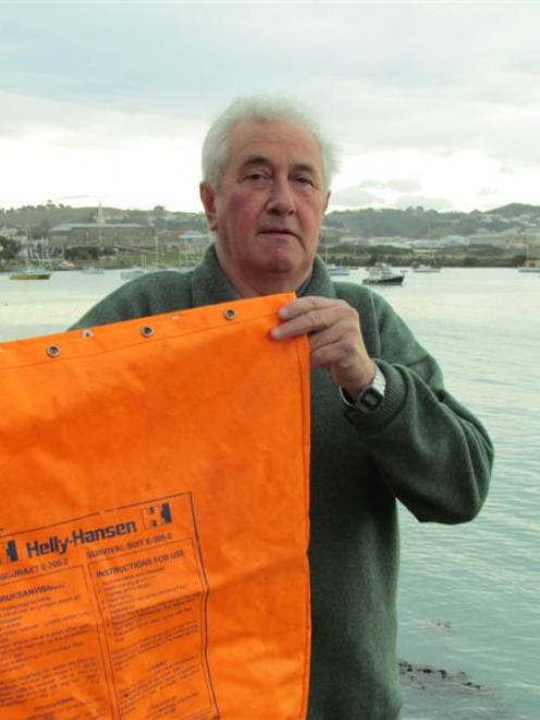 Jim Curwood holds a survival bag used by Longva III sailors after they were taken off  the fire...