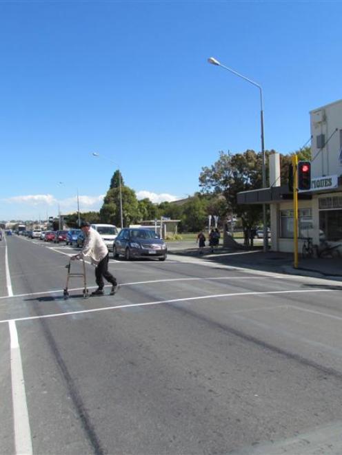 Jim Fraser, with his walking frame, uses the Oamaru north end pedestrian crossing on Thames St...