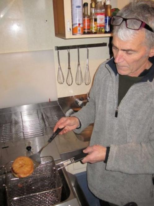 Jim takes the pie out of the deep fryer.