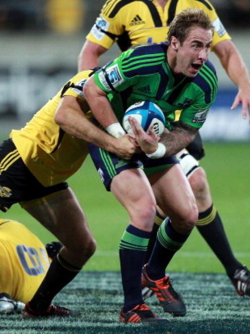 Jimmy Cowan of the Highlanders is tackled during the Super 15 match against the Hurricanes at...