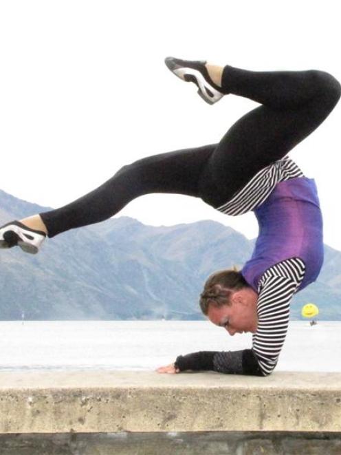 Jodie Glinster demonstrates her acrobatic skills on the shores of Lake Wakatipu in Queenstown...