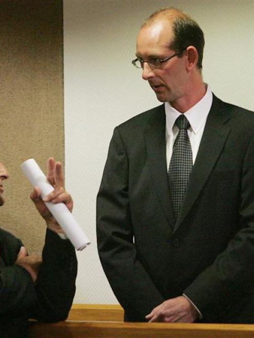 Joe Karam speaks with David Bain as he stands in the dock at High Court, Christchurch, at his...