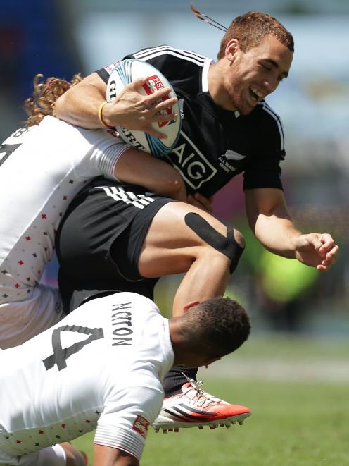 Joe Webber of New Zealand is tackled by Dan Norton and Dan Bibby of England during the 2014 Gold...