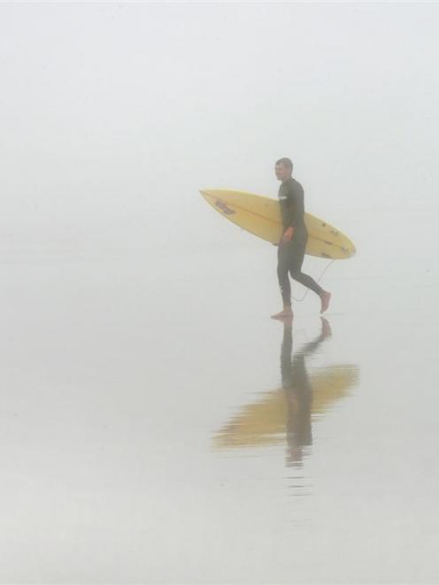 Johannes Albers, of Germany, searches for a good surfing spot on Dunedin's St Clair Beach, which...
