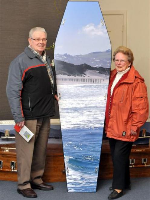 John and Maureen Banks inspect one of the caskets on display at Dignity Funeral Services' casket...