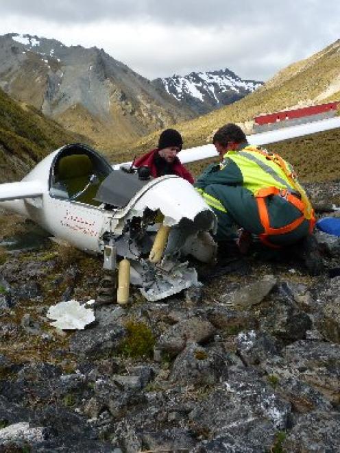 John Lambeth treats injured glider pilot Alex Marshall after a "heavy landing" 35km west of...