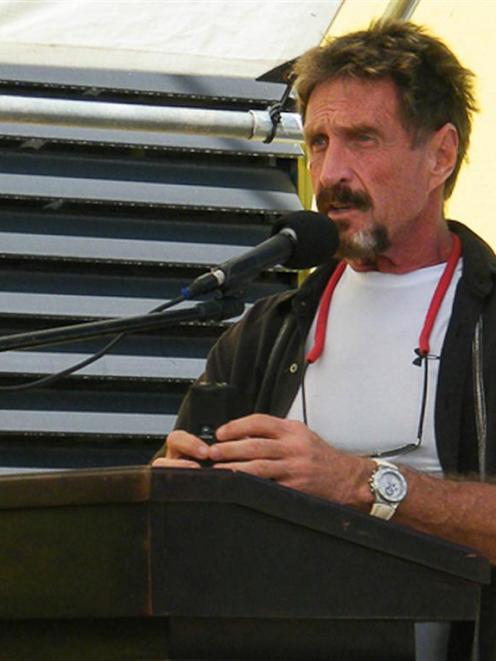 John McAfee is seen speaking in San Pedro, Belize, last week. McAfee says he has gone into hiding...