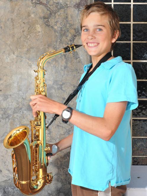 John McGlashan College pupil Ben Mitchell (14), of Dunedin, prepares to play his alto saxophone...