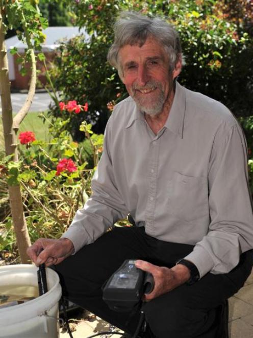 John McGlashan College science teacher Andrew Innes uses a water monitoring device in one of the...