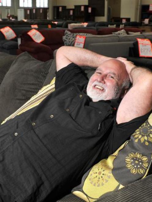 John's Furniture Warehouse sales manager Ian Cameron puts his feet up yesterday after a busy...