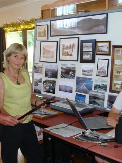 John Taylor (left) and Claire Kane study photos about to be scanned by Kurt Gurden (right) for...
