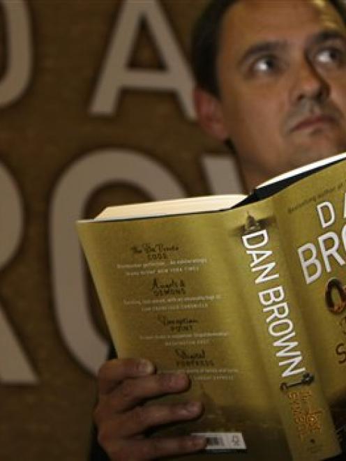 Jon Howells,  press officer for Waterstone's booksellers,  poses for the cameras as he reads a...