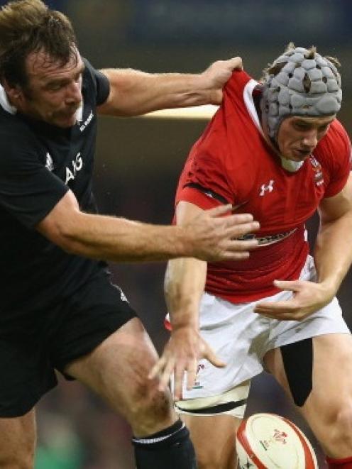 Jonathan Davies of Wales spills the ball under the challenge of Andrew Hore. Photo by Getty