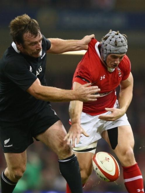 Jonathan Davies (right) of Wales spills the ball under the challenge of Andrew Hore of New...