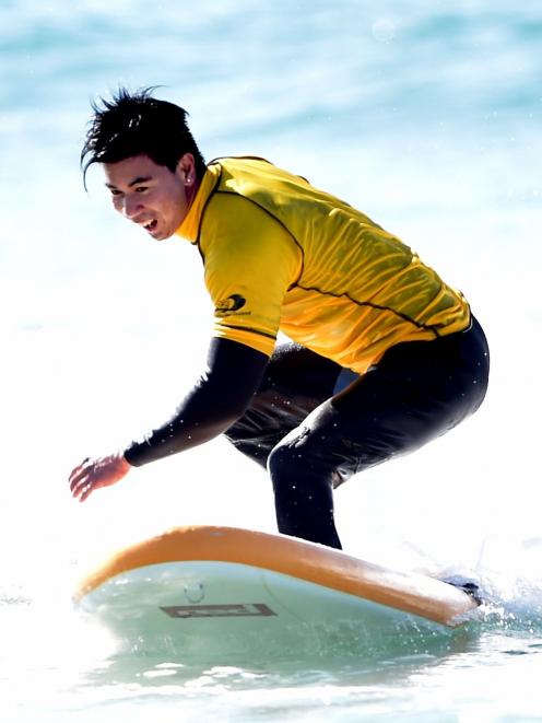 Jono Brownjohn takes part in the surfing event at the Halberg Water Sports Day at Brighton Beach...