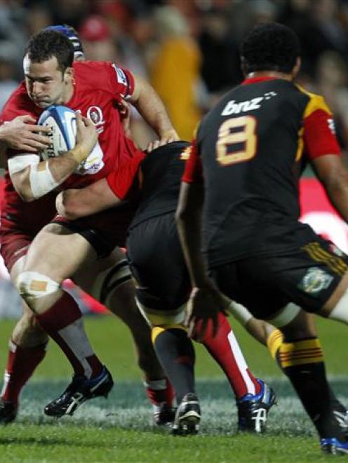 Jono Lance is tackled by Craig Clarke in tonight's Super Rugby match at Waikato Stadium, Hamilton...