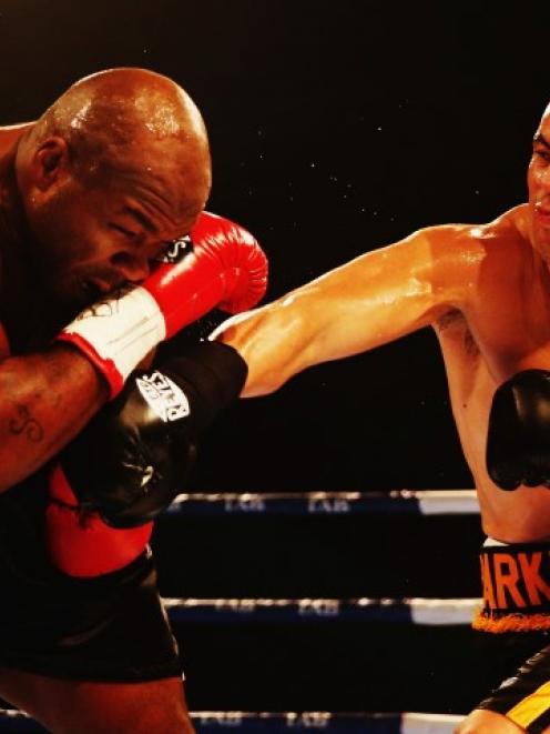 Joseph Parker lands a punch on Sherman Williams during their heavyweight title at Trusts Stadium...