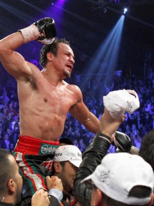 Juan Manuel Marquez of Mexico celebrates his knockout victory over Manny Pacquiao of the...