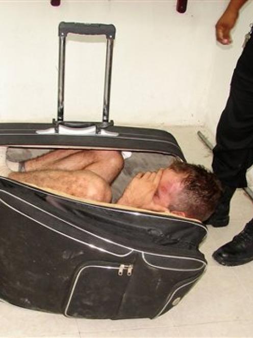 Juan Ramirez Tijerina is seen curled inside a suitcase after he tried to escape from prison with...