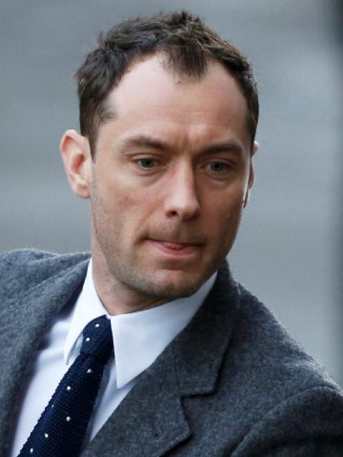 Jude Law arrives to give evidence at the Old Bailey courthouse in London. REUTERS/Suzanne Plunkett