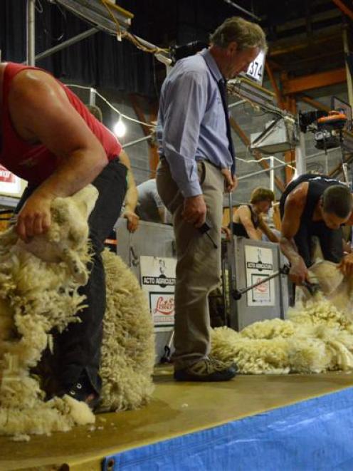 Judge Grant Bradfield (centre) oversees shearers Gareth Daniel (left, Wales) and Rowland Smith ...