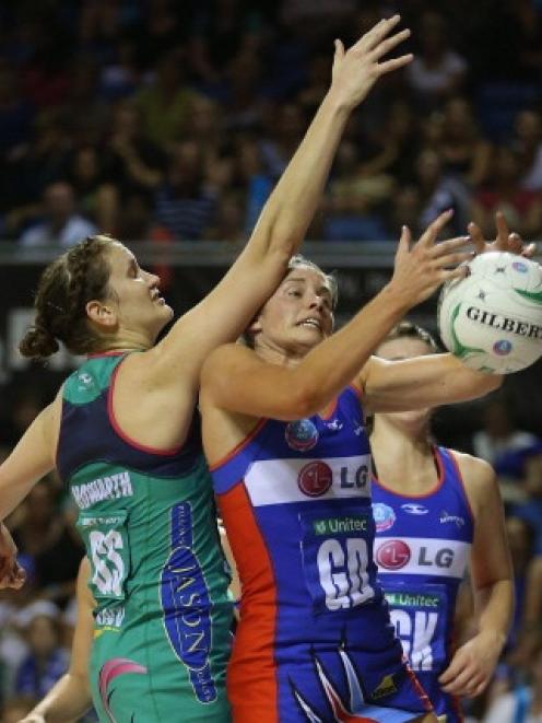 Julie Corletto of the Mystics (right) and Karyn Howarth of the Vixens contest for the rebound...